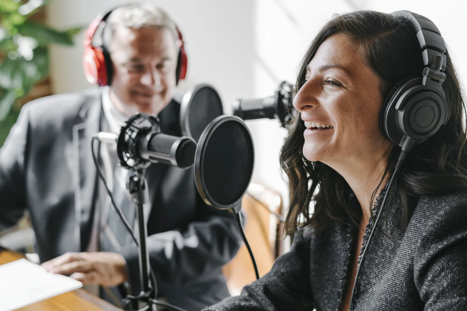 A presenter speaking into a studio microphone